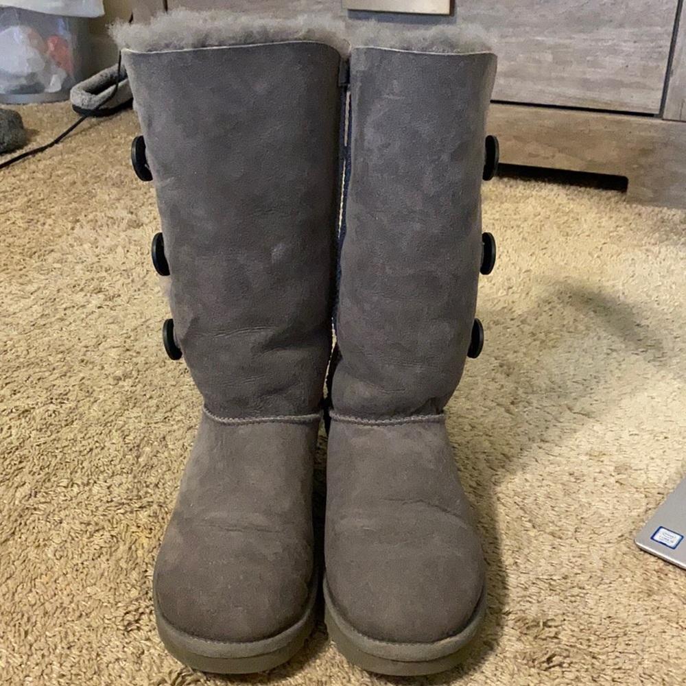 Gray tall UGG boots with button accents on sides
